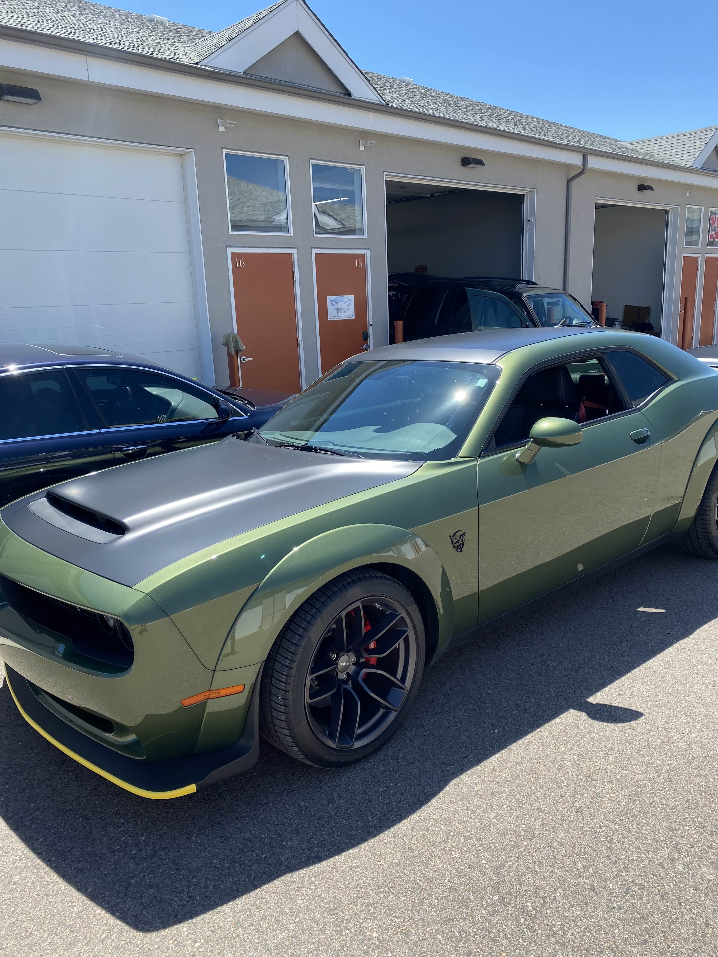 Lime green Dodge Challenger at outdoor garage
