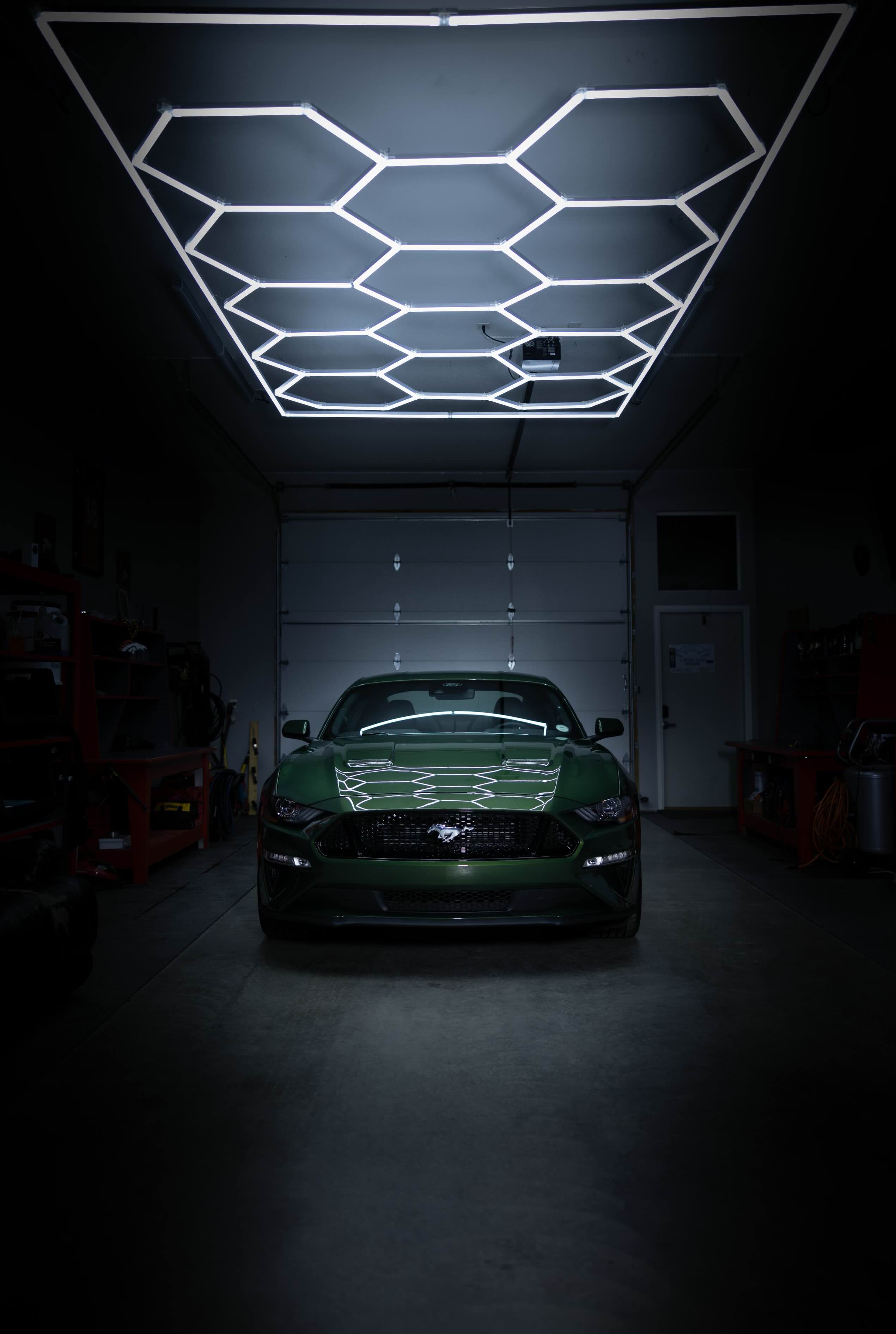 Green Mustang GT under hexagon lights showcasing premium detailing