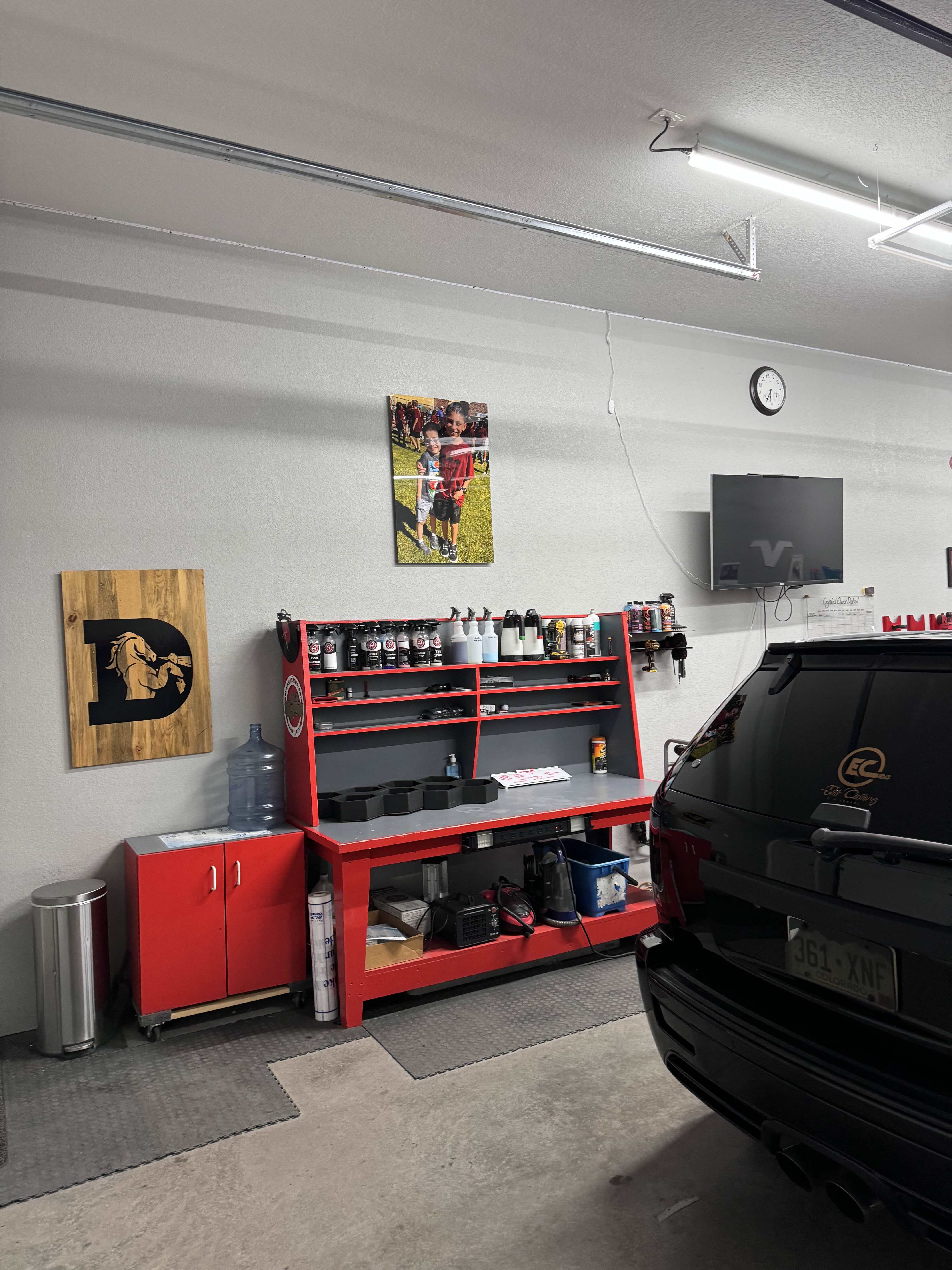 Product station with red shelving and organized supplies