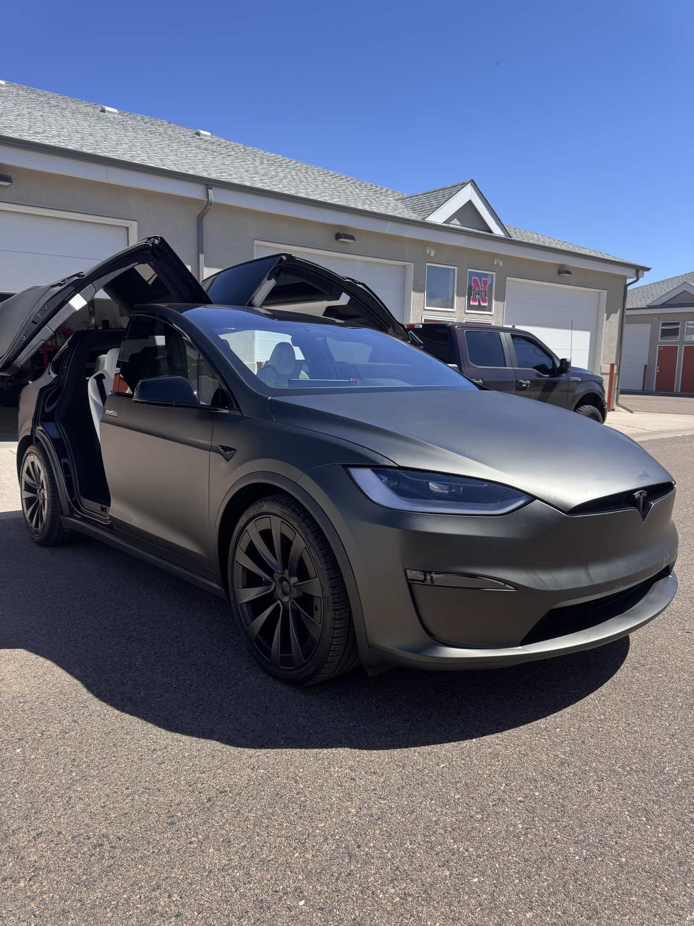 Tesla Model X with matte grey vinyl wrap - falcon wing doors open