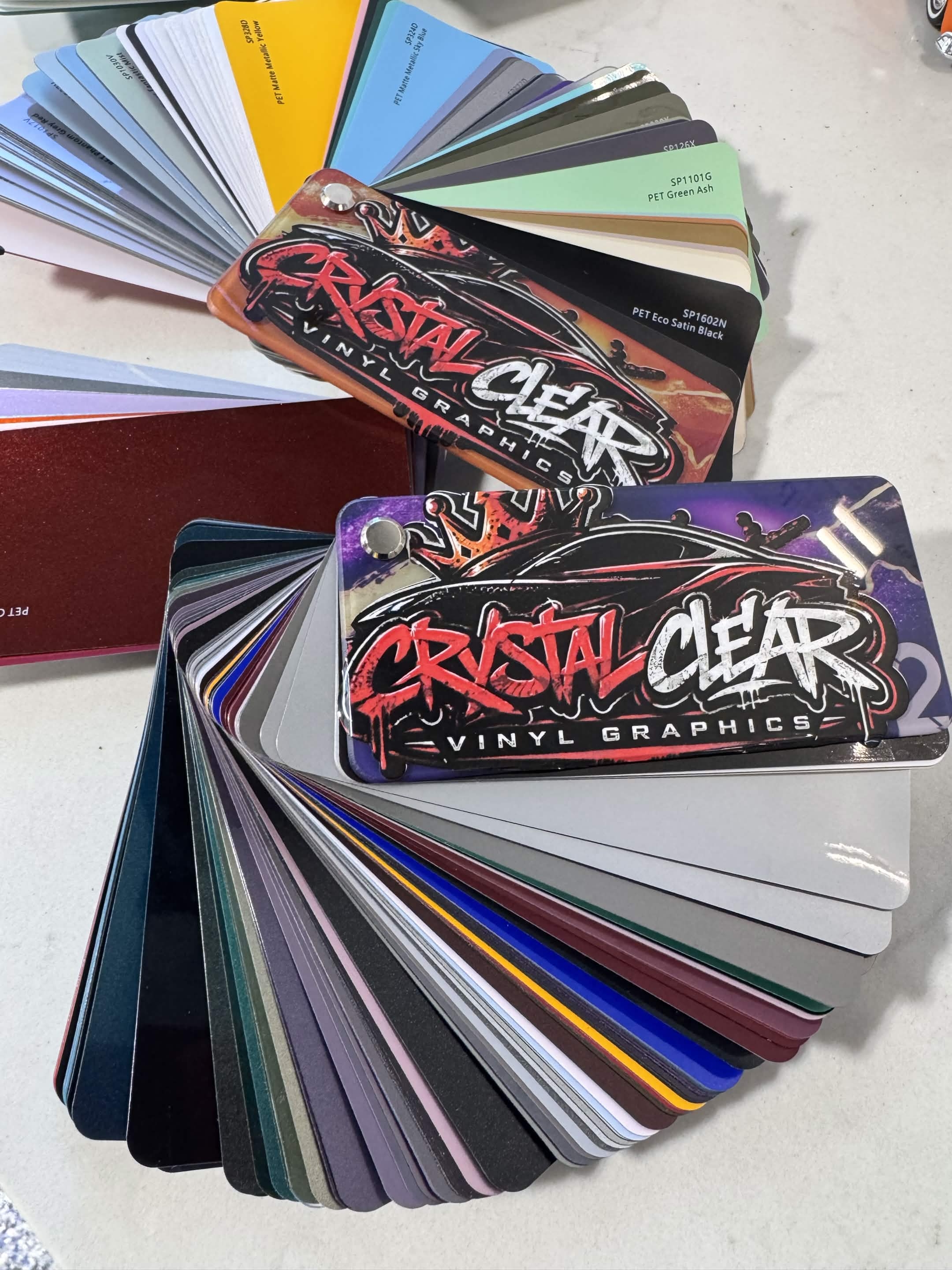 Crystal Clear Vinyl Graphics vinyl swatch books spread out showing color range