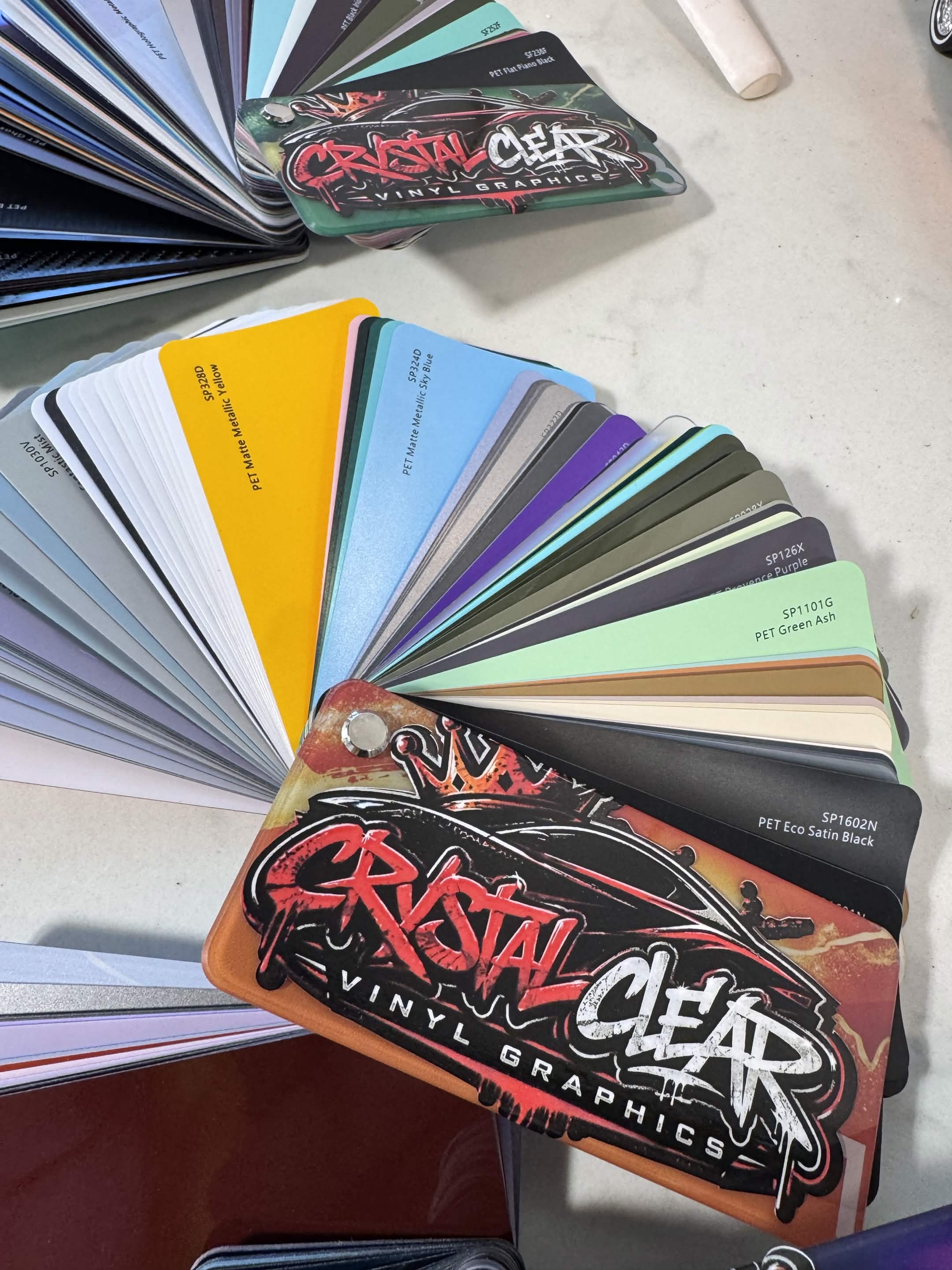 Close up of Crystal Clear Vinyl Graphics vinyl swatch fan with specialty finishes